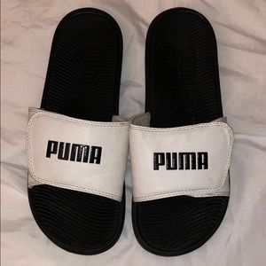 Black and white Puma slides